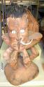 Large painted wooden stool with carved head having boar tusks through +