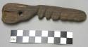 Wooden knife-shaped artifact with perforation at hilt end, notching along edge