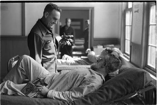 Man looking down on a patient lying in bed