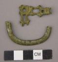 Metal, personal, buckle fragments, one curved, one decorative, corroded