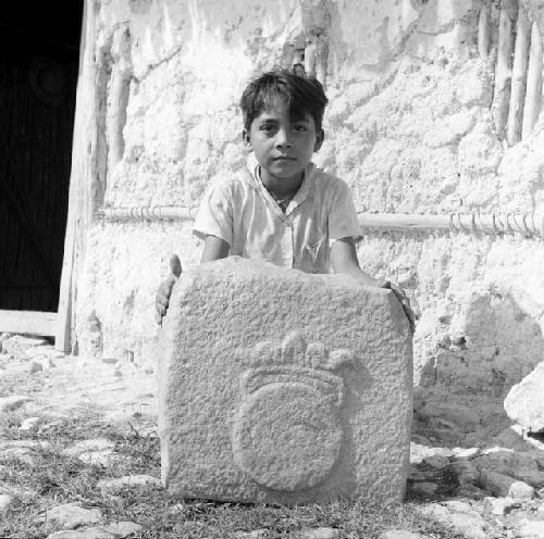 Boy with sculpted stone at Sayaxche