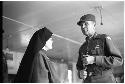 Nun speaking to a man wearing military clothing