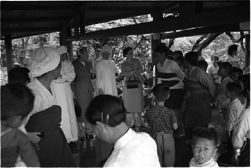 Gathering of women and children under a pavillion