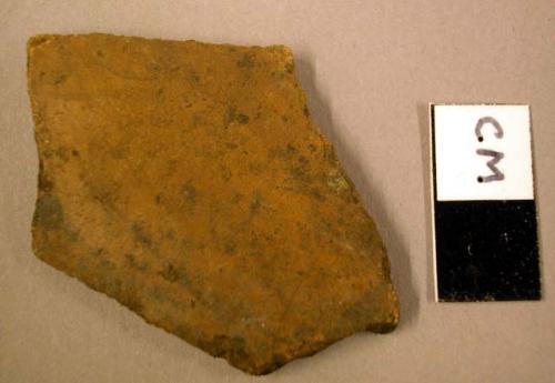 Ceramic body sherd, black spotting on 1 side, orange ware