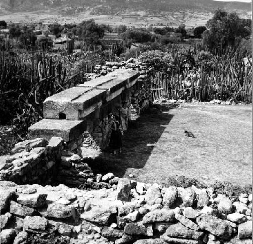 Woman and Child standing by masonry in the arroyo group at Mita