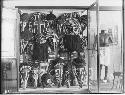 Historical photograph of masks in case at Peabody Museum