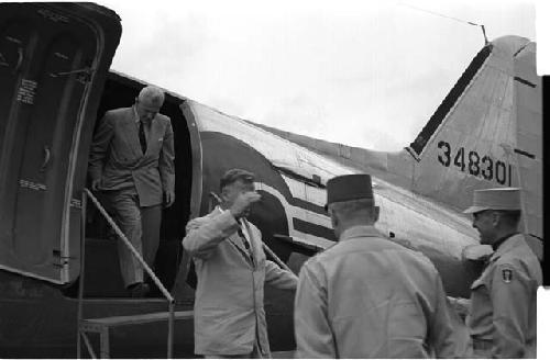 Men exiting an airplane