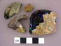 Glass, olive green bottle glass, dark and gold colored flakes on fragments