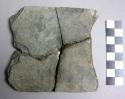 Ground stone tablet, flat, more or less square, mended, losses
