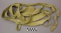 Crow bison hide rope; knot at one end. Wide and flat leather