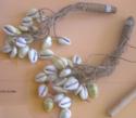 Rattles - cowrie shells attached by twisted fiber to wooden handle +