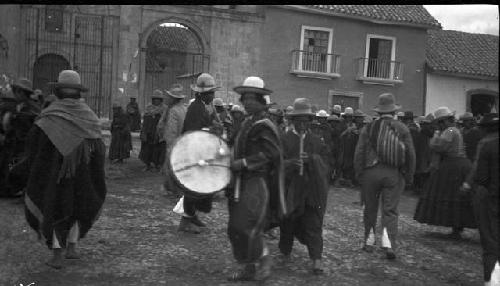 Musicians performing for crowd in front of building