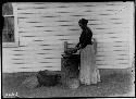 Seneca woman sifting corn meal