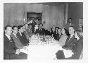 Gordon Willey at the head of a formal dinner table with others c. 1950's