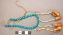 Ornament of blue beads with 4 shells hanging off on strings