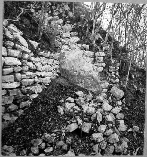 High platform wall and North wall of stairway to Castillo