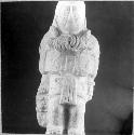 Ceramic? figurine, standing male, elaborate necklace. E-2, C 1, 26-Bis