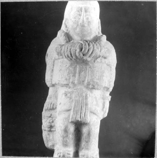 Ceramic? figurine, standing male, elaborate necklace. E-2, C 1, 26-Bis