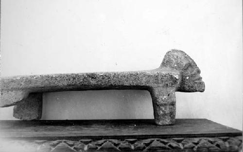 Flat 4-legged metate.