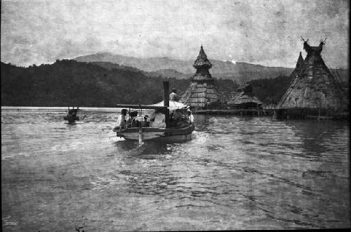 Triangular homes along river with motorized boat