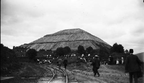 Group of people gathering around base of pyramid