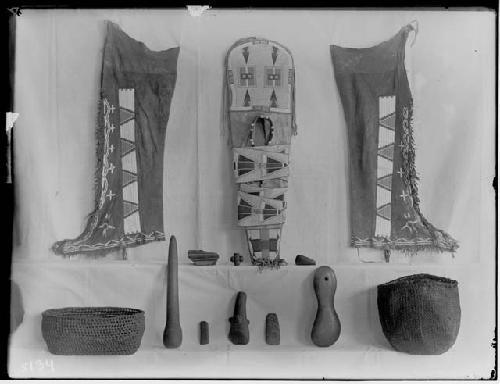 Cheyenne cradle and leggings, stone implements and baskets