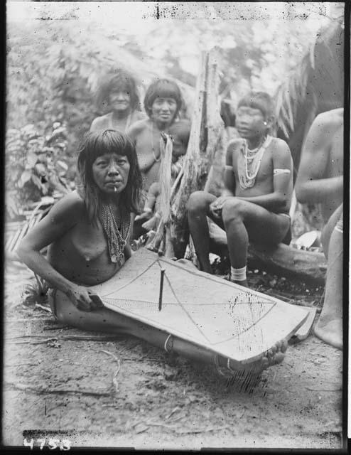 Group of women, one with a grater