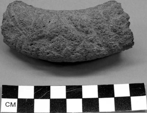 Curved sculpture fragment, possibly metate handle.