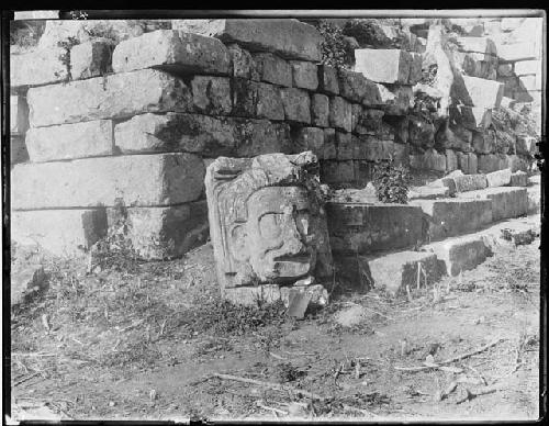 Face sculpture leaned against wall