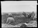 Men digging in bending position