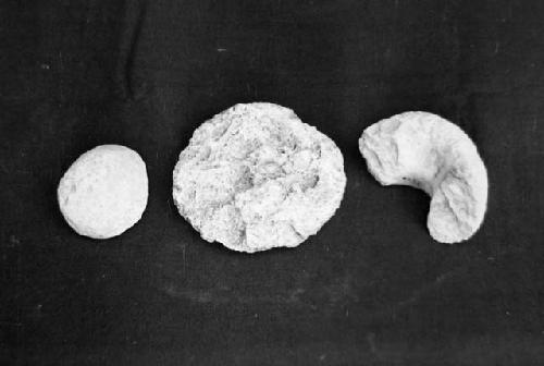 3 stone objects. a/ Lot E-73, hammerstone, cat #54-46; b, Lot E-73, skin scraper