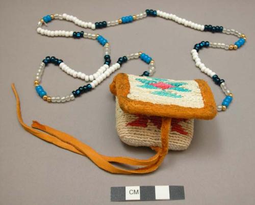 Miniature woman's bag on beaded necklace