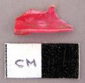 Plastic, small red plastic fragment