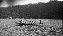 Men rowing a double outrigger dugout canoe
