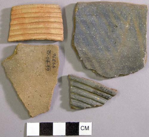 Rim and boby sherds from multiple vessels, two with exterior corrugation - red on gray