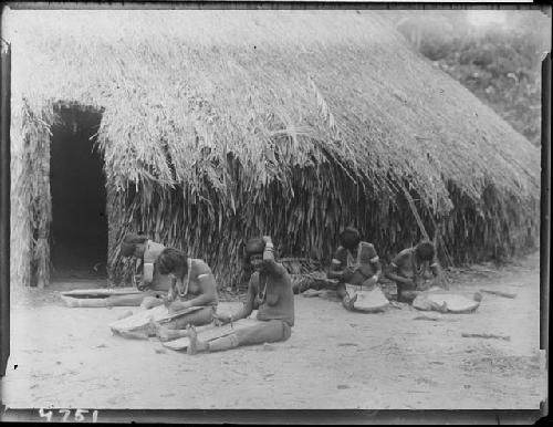 Girls grating cassava