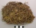 Plant fiber fragments, shredded, dark brown