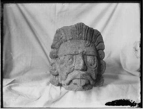 Sculpture of face showing filed teeth on display