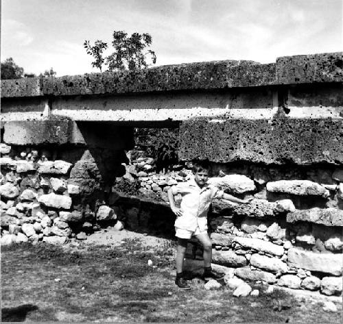 Child standing by masonry in the arroyo group