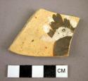 Potsherd showing feathers?