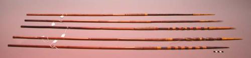 Bamboo arrows decorated with colored raffia