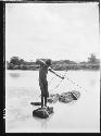 Boy Fishing with Bow and Arrow