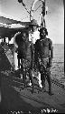 Thomas Barbour and two indigenous men on deck of ship