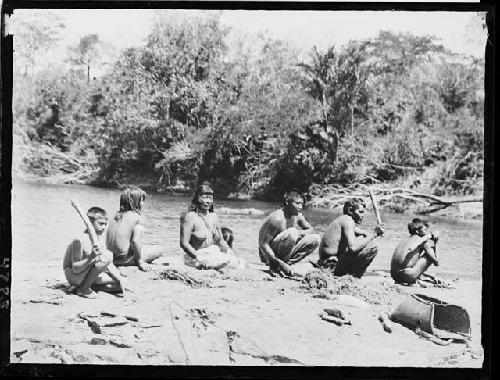 Beating poison on rocks for poisoning fish