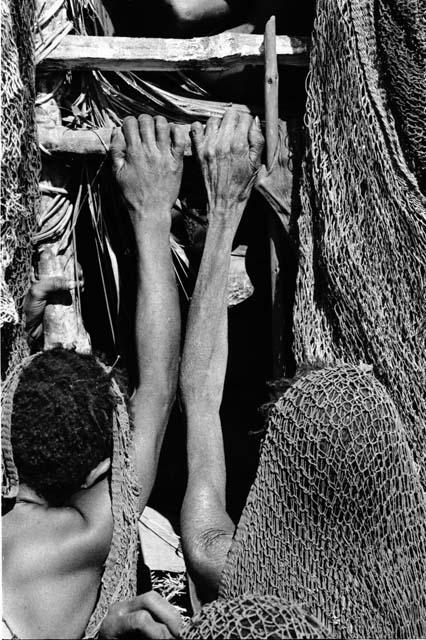 Women holding onto funeral pyre