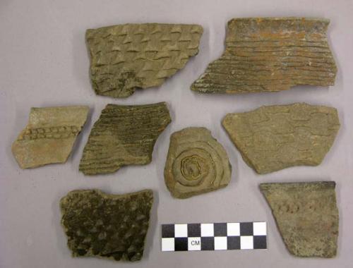 Ceramic sherds, corrugated body and rim, some from jar