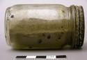 Unidentified grey/brown powder in glass jar w/ metal lid