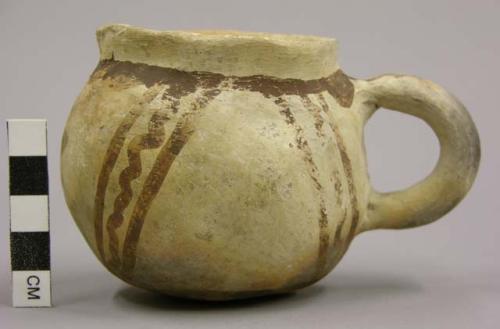 Cup, eccentric painted ware. brown on buff. 7.5 x 11.6 cm.