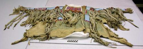 Crow buckskin shirt. Decorated w/ beadwork, long tubes of weasel fur & cloth