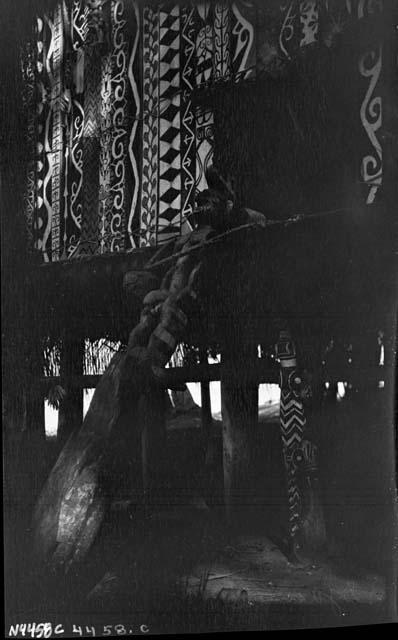 Entryway of decorated hut on stilts with intricately painted facade